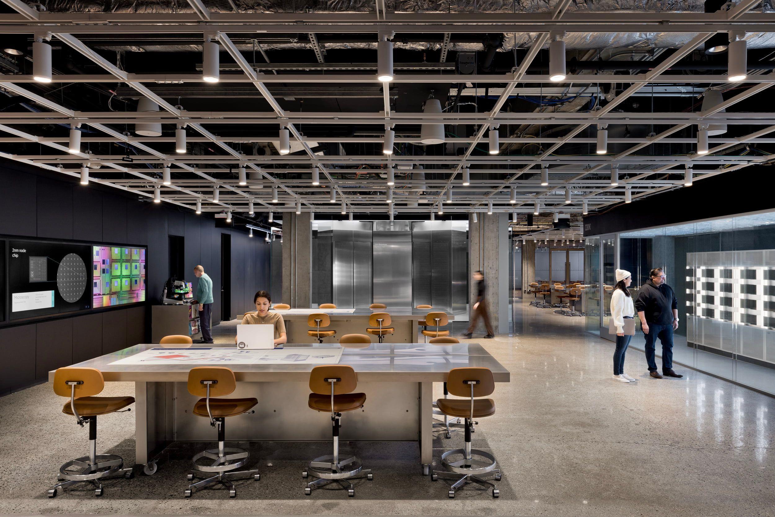 image of an industrial space with several people milling about or sitting at tables